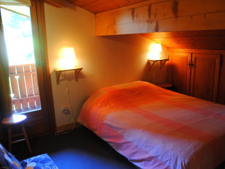 Cozy chalet bedroom with wooden accents and a comfortable bed.