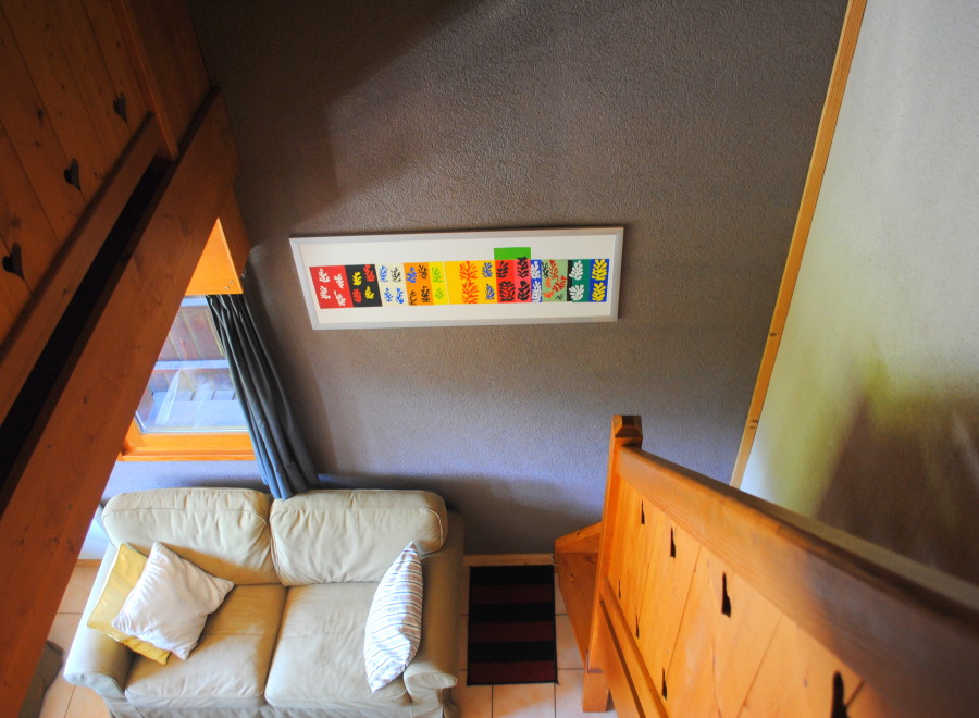 Cozy chalet living room with a comfy couch and unique wall art.