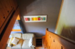 Cozy chalet living room with a comfy couch and unique wall art.