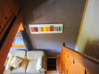 Cozy chalet living room with a comfy couch and unique wall art.