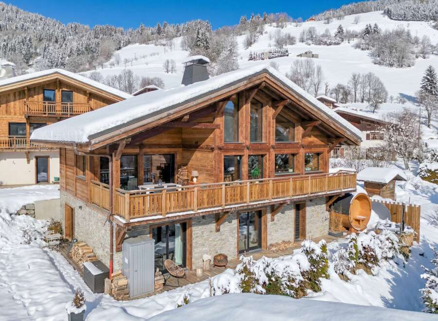 Experience the ultimate winter getaway in this stunning chalet nestled in a snowy landscape.