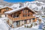 Experience the ultimate winter getaway in this stunning chalet nestled in a snowy landscape.