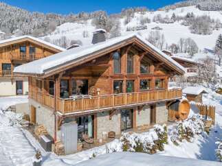Experience the ultimate winter getaway in this stunning chalet nestled in a snowy landscape.