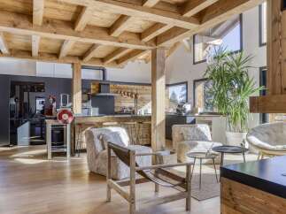 This stunning property boasts a rustic yet modern design, featuring exposed wooden beams and a spacious open-plan layout.