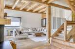 This stunning property boasts a warm and inviting interior with exposed wooden beams and a cozy fireplace.