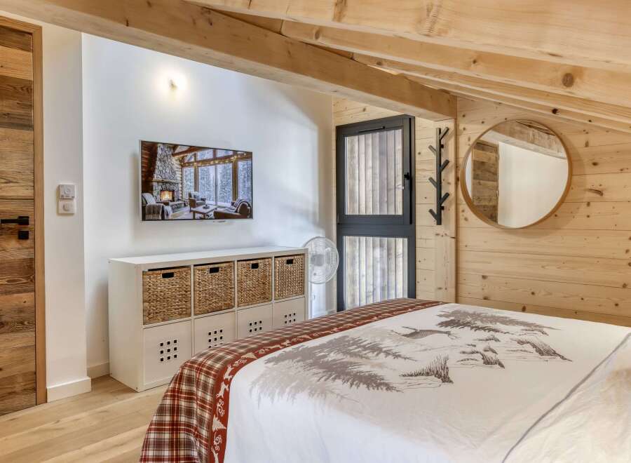 This cozy bedroom features a rustic design with wooden accents and a warm, inviting atmosphere.