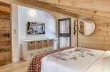 This cozy bedroom features a rustic design with wooden accents and a warm, inviting atmosphere.
