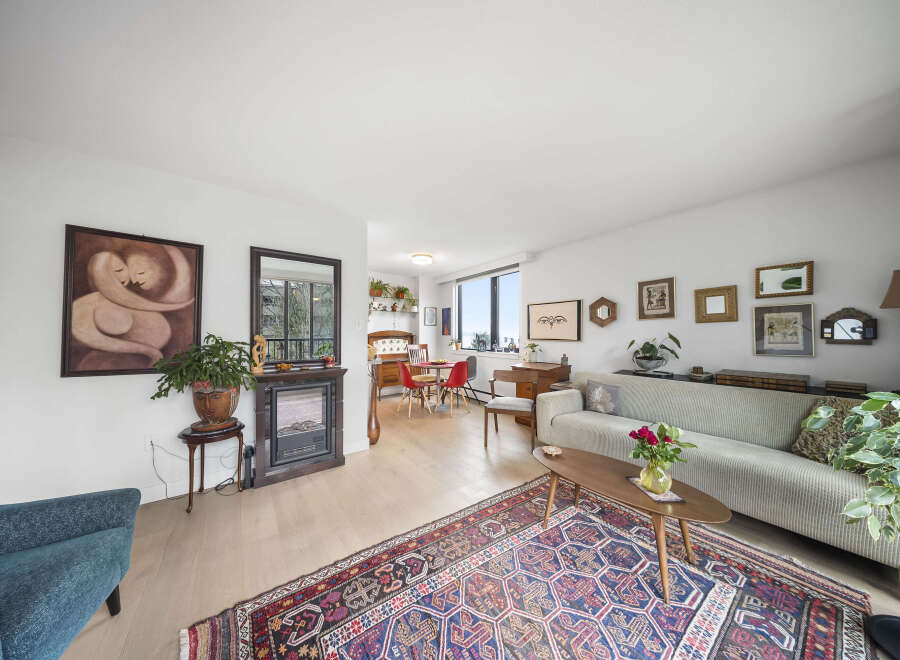 Step into this inviting living space, featuring a cozy fireplace and a stylish rug that adds warmth and character.