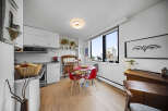 This stylish condo features a modern kitchen with stainless steel appliances and ample cabinet space.