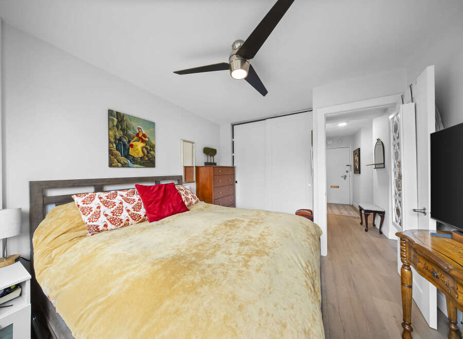 Step into this inviting bedroom, featuring a comfortable bed with plush bedding and decorative pillows.