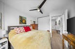 Step into this inviting bedroom, featuring a comfortable bed with plush bedding and decorative pillows.