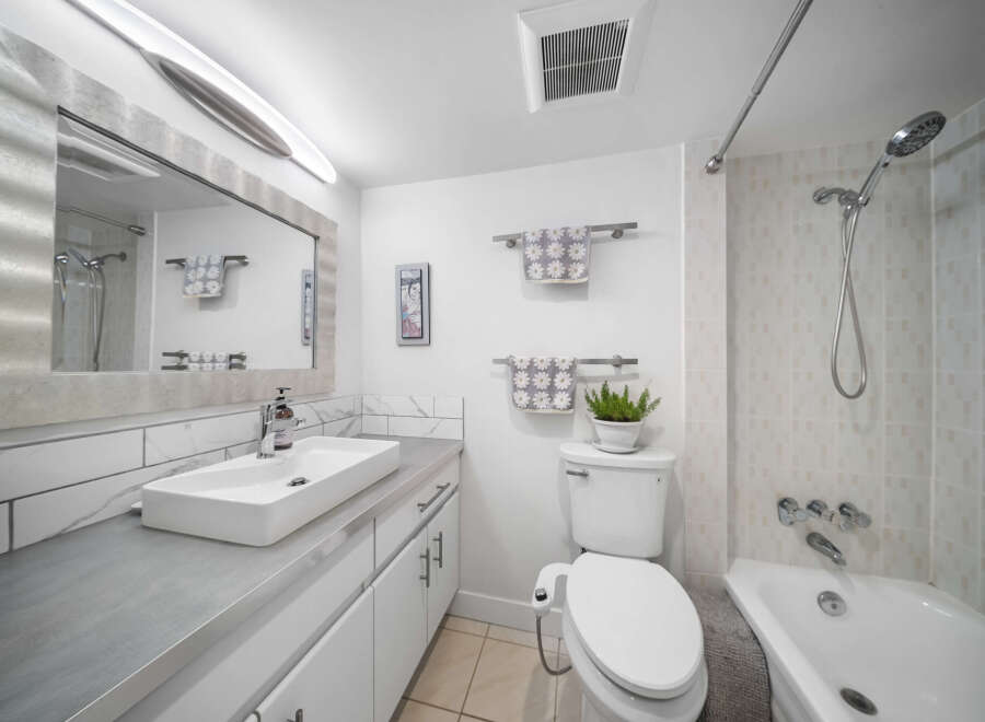 This modern bathroom boasts a sleek design with a minimalist aesthetic.