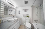 This modern bathroom boasts a sleek design with a minimalist aesthetic.