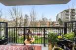 Enjoy stunning views from this beautiful balcony! This outdoor space features a charming table, lush greenery, and a cozy rug, perfect for relaxing or entertaining.