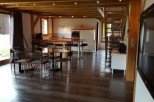 This stunning chalet boasts an open-plan living area with a sleek, modern kitchen and dining space.