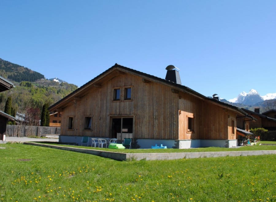 This stunning chalet boasts a spacious wooden exterior, offering breathtaking mountain views.