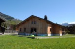 This stunning chalet boasts a spacious wooden exterior, offering breathtaking mountain views.