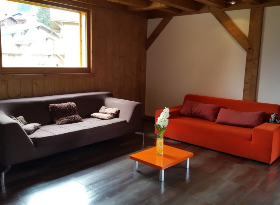 Cozy living room with brown and orange sofas, offering a relaxing atmosphere.