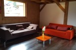Cozy living room with brown and orange sofas, offering a relaxing atmosphere.
