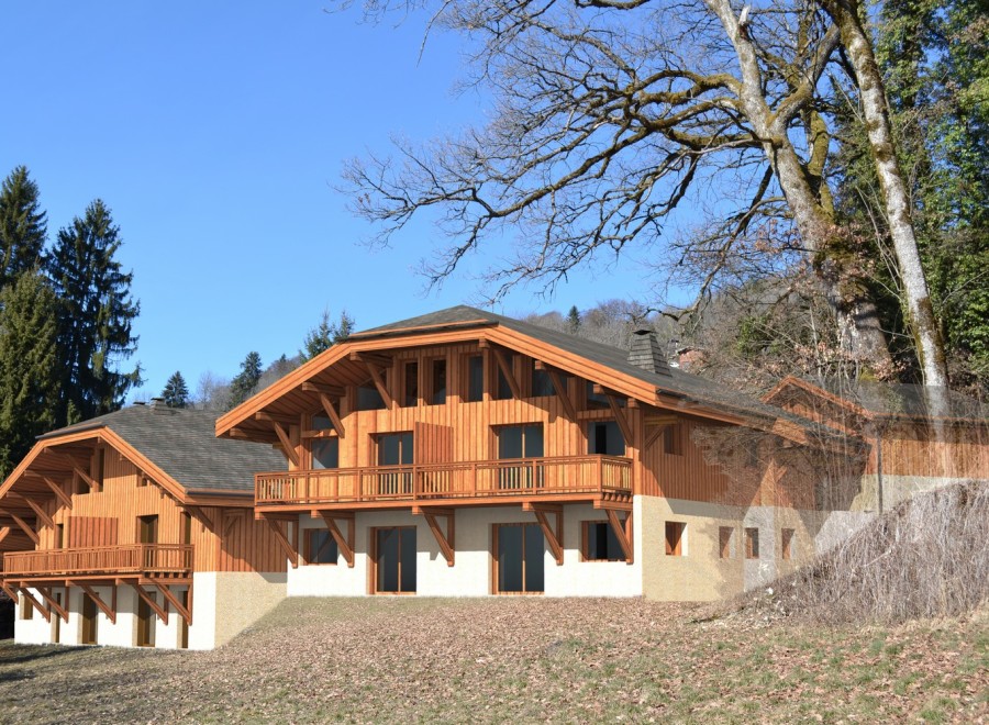 This stunning chalet boasts a beautiful wooden exterior, spacious balconies, and large windows offering breathtaking views.