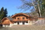 This stunning chalet boasts a beautiful wooden exterior, spacious balconies, and large windows offering breathtaking views.