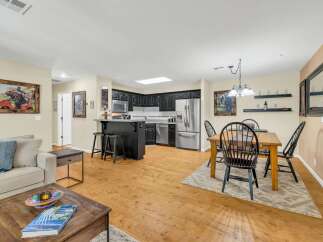 Discover this stunning property featuring a modern kitchen with stainless steel appliances and sleek black cabinetry.