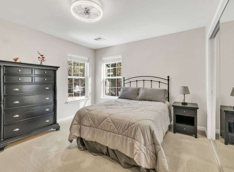 This inviting bedroom boasts a serene atmosphere, perfect for relaxation.