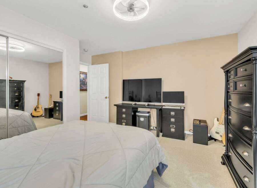 Step into this inviting bedroom, featuring a comfortable bed and ample space.