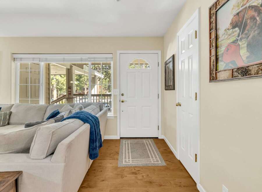 Step into this inviting living space, featuring a cozy sofa and a bright, airy atmosphere.