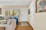 Step into this inviting living space, featuring a cozy sofa and a bright, airy atmosphere.