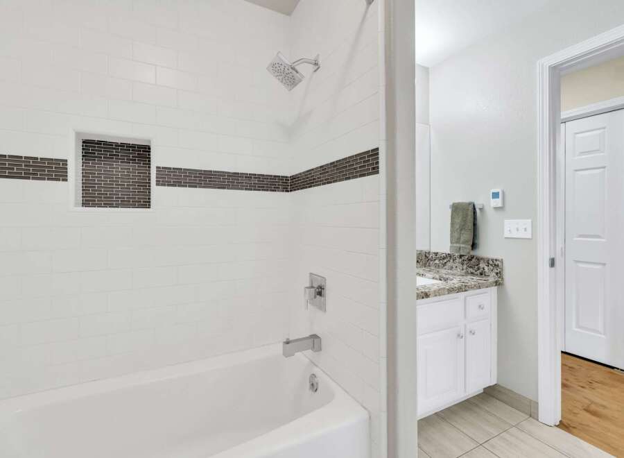 Step into a beautifully designed bathroom featuring a modern shower with a sleek design.