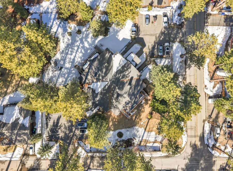 Nestled amidst a serene, snow-dusted landscape, this property boasts a unique architectural design with a spacious roof and multiple levels.