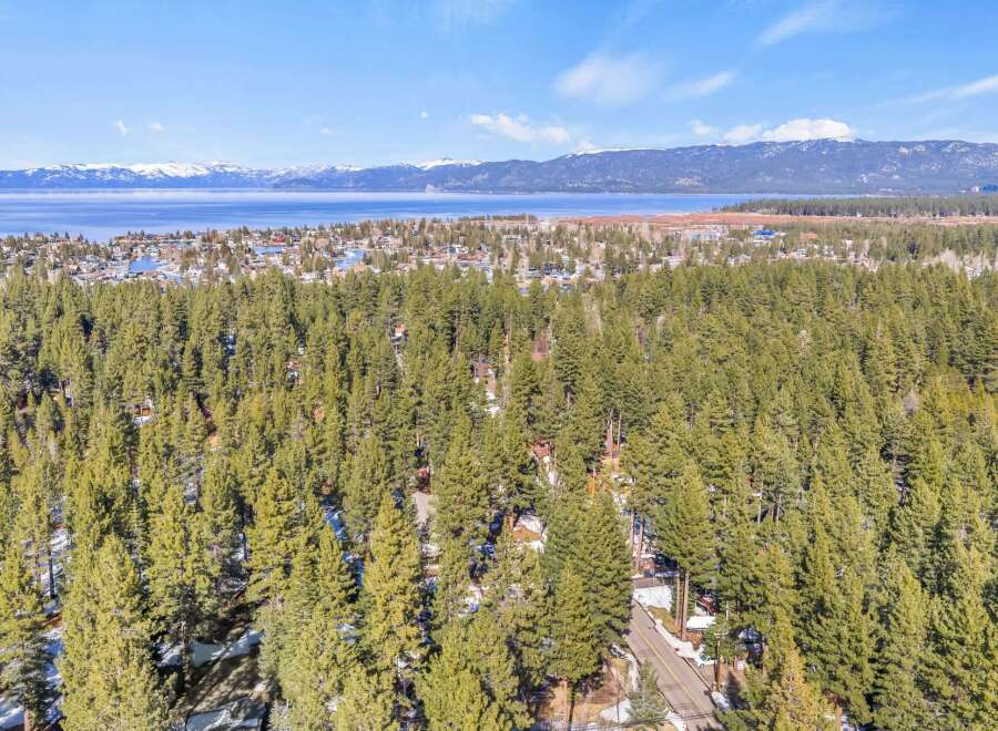 Discover a stunning property nestled amidst a lush forest with breathtaking lake views.