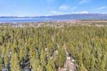 Discover a stunning property nestled amidst a lush forest with breathtaking lake views.