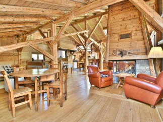 Step into rustic elegance with this stunning property featuring exposed wooden beams and a cozy fireplace.