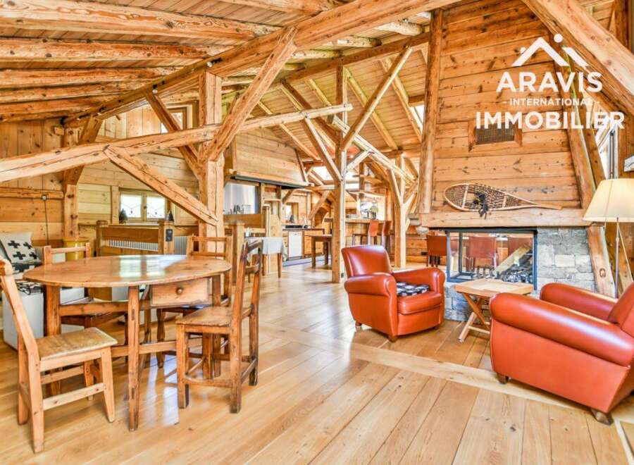 Discover the charm of this stunning property, featuring a rustic interior with exposed wooden beams and a cozy fireplace.