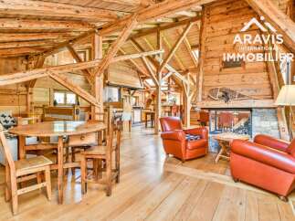 Discover the charm of this stunning property, featuring a rustic interior with exposed wooden beams and a cozy fireplace.