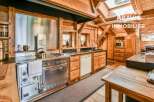 Step into rustic elegance with this stunning kitchen! Featuring a stainless steel stove, wooden cabinets, and a charming wooden interior, this space is perfect for cooking and entertaining.