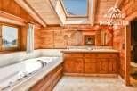 This stunning bathroom boasts a rustic charm with its wooden walls and ceiling, creating a warm and inviting atmosphere.