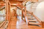 Step into rustic elegance with this stunning property, showcasing exquisite wooden craftsmanship throughout.