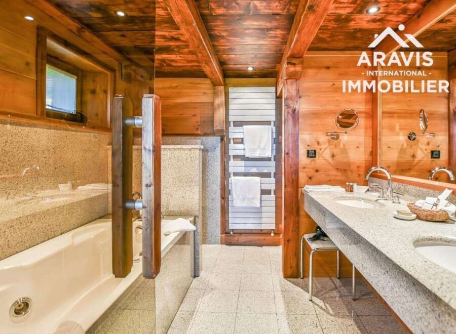 Experience luxury in this stunning bathroom featuring a beautiful wooden ceiling and walls, creating a warm and inviting atmosphere.