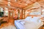 Experience rustic charm in this stunning bedroom featuring exquisite wooden paneling and a cozy ambiance.