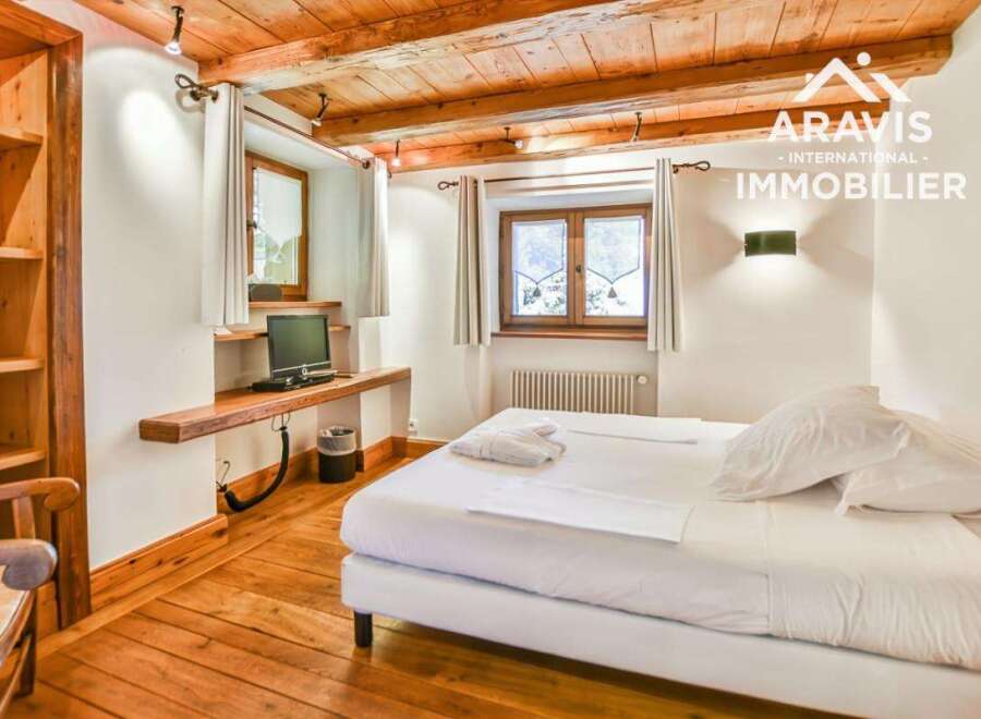 Discover the charm of this cozy bedroom, featuring a wooden ceiling and floors that exude warmth and character.