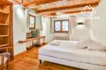 Discover the charm of this cozy bedroom, featuring a wooden ceiling and floors that exude warmth and character.