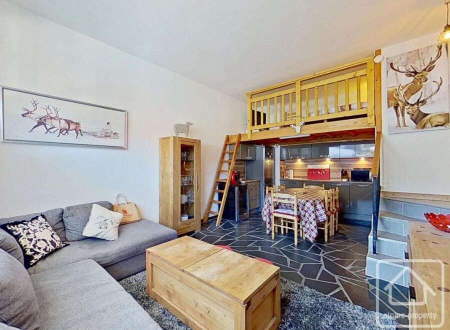 Discover this charming property featuring a cozy living area with a comfortable sofa and decorative pillows.