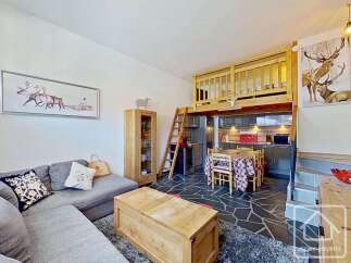 Discover this charming property featuring a cozy living area with a comfortable sofa and decorative pillows.
