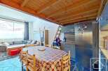 Discover this charming property featuring a cozy dining area with a rustic wooden table and chairs.