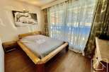 This cozy bedroom features a rustic wooden bed frame, creating a warm and inviting atmosphere.