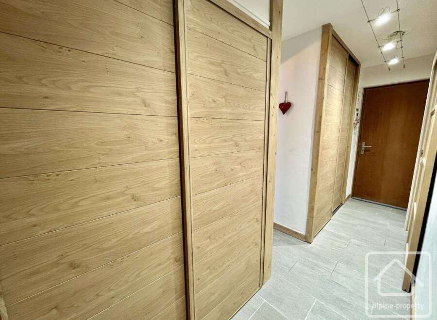 This stunning property boasts elegant wooden doors that add a touch of sophistication to the interior.