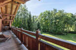 Enjoy the tranquility of nature from this stunning wooden balcony.